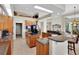 Open kitchen with granite countertops, wood cabinets, and an island at 8323 W Lake Marion Rd, Haines City, FL 33844