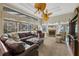 Living room with fireplace, lake view, and comfortable leather furniture at 8323 W Lake Marion Rd, Haines City, FL 33844