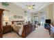Spacious main bedroom with large bed, water view, and seating area at 8323 W Lake Marion Rd, Haines City, FL 33844