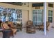Relaxing lakefront patio with fire pit and wicker furniture at 8323 W Lake Marion Rd, Haines City, FL 33844