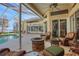 Inviting pool area with covered patio, fire pit, and lake view at 8323 W Lake Marion Rd, Haines City, FL 33844
