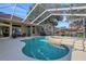 Large, freeform pool with a spacious deck and lake view at 8323 W Lake Marion Rd, Haines City, FL 33844