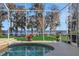 Screened spa with lake view, lush landscaping, and steps at 8323 W Lake Marion Rd, Haines City, FL 33844