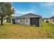 Single-story home with a large backyard, screened porch, and mature trees at 918 Revere Ave, Haines City, FL 33844
