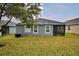 House exterior view showcasing a screened patio and grassy backyard at 918 Revere Ave, Haines City, FL 33844