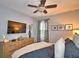 Bright bedroom with a large TV, dresser, and comfy bed at 918 Revere Ave, Haines City, FL 33844