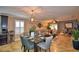 Open concept dining room with glass table and modern chandelier at 918 Revere Ave, Haines City, FL 33844