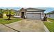 Curb appeal abounds in this one-story home with a gray exterior at 918 Revere Ave, Haines City, FL 33844