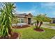 Landscaped front yard with palm trees and drought-tolerant plants at 918 Revere Ave, Haines City, FL 33844
