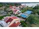 Stunning aerial view of the community showcasing a pool, tennis court, and lake access at 1 Casarena Ct, Winter Haven, FL 33881