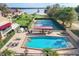 Aerial view showcasing a pool, tennis courts, and lush landscaping at 1 Casarena Ct, Winter Haven, FL 33881