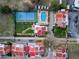 Aerial view showcasing a community with pool, tennis court, and manicured lawns at 1 Casarena Ct, Winter Haven, FL 33881