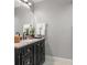 Stylish bathroom featuring a sleek black vanity with a modern sink and fixtures at 1 Casarena Ct, Winter Haven, FL 33881