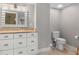 Elegant bathroom with custom vanity and granite countertops alongside the commode and other fixtures at 1 Casarena Ct, Winter Haven, FL 33881