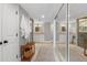 Hallway to primary bathroom with dual vanities, mirrored closets and a rug runner at 1 Casarena Ct, Winter Haven, FL 33881
