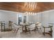 Cozy dining room featuring modern lighting, a glass table and seating for six at 1 Casarena Ct, Winter Haven, FL 33881