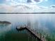 Picturesque waterfront view of a private wooden dock on a calm lake at 1 Casarena Ct, Winter Haven, FL 33881