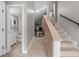 Inviting foyer with staircase, neutral tile flooring, and half-bath access at 1 Casarena Ct, Winter Haven, FL 33881
