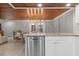 An open kitchen with stainless steel appliances, granite countertops, and wood ceiling adjoining the dining area at 1 Casarena Ct, Winter Haven, FL 33881