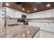 Bright kitchen features granite counters, stainless appliances, and unique wood ceiling at 1 Casarena Ct, Winter Haven, FL 33881