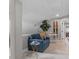 Cozy living room with blue loveseat, plant, and hallway view at 1 Casarena Ct, Winter Haven, FL 33881