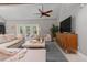 Comfortable living room with plush seating, television, and plenty of natural light at 1 Casarena Ct, Winter Haven, FL 33881