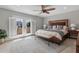 Bedroom features private balcony, tile floor, and ceiling fan at 1 Casarena Ct, Winter Haven, FL 33881
