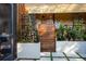 Charming outdoor shower features stone walls and a wooden partition, surrounded by greenery and modern planters at 1 Casarena Ct, Winter Haven, FL 33881