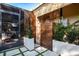 Stylish outdoor shower area with stone accents, wooden privacy screen, and lush landscaping, a private oasis at 1 Casarena Ct, Winter Haven, FL 33881