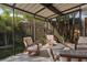 Relaxing outdoor patio with comfortable chairs, perfect for enjoying the serene garden views and fresh air at 1 Casarena Ct, Winter Haven, FL 33881
