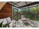 Bright sunroom with tiled floors, comfortable seating, and a view of the lush backyard at 1 Casarena Ct, Winter Haven, FL 33881