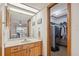 Bathroom featuring vanity with cabinets, sink, a large mirror, and walk-in closet space at 10202 Village Dr # 22, Lake Wales, FL 33898