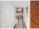 Bright hallway leading to an open-concept living and dining area with wood-look floors at 10202 Village Dr # 22, Lake Wales, FL 33898