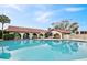 Community pool with sun umbrellas and tables, surrounded by beautiful landscaping at 10202 Village Dr # 22, Lake Wales, FL 33898