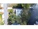 Aerial view of lakefront home nestled among mature trees with private dock and waterfront access at 1048 Sunset Trail, Babson Park, FL 33827