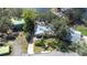 Aerial view of a home with a landscaped yard, driveway, mature trees, and easy access to the serene lake nearby at 1048 Sunset Trail, Babson Park, FL 33827