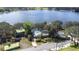 An aerial view shows a home with a well-kept yard, driveway, mature trees, and convenient access to the serene lake nearby at 1048 Sunset Trail, Babson Park, FL 33827