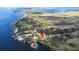 Panoramic aerial view of a lakeside community surrounded by lush greenery and serene waters at 1048 Sunset Trail, Babson Park, FL 33827