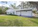 Lovely backyard featuring green lawn, mature trees, and waterfront views for peaceful relaxation at 1048 Sunset Trail, Babson Park, FL 33827