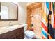 A clean bathroom features a vanity, toilet, and shower with decorative curtain at 1048 Sunset Trail, Babson Park, FL 33827