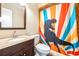 A clean bathroom features a vanity, toilet, and shower with decorative curtain at 1048 Sunset Trail, Babson Park, FL 33827