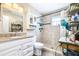 A bright bathroom with a glass shower door and granite countertop vanity at 1048 Sunset Trail, Babson Park, FL 33827