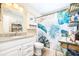 Well-lit bathroom with a granite countertop, shower with a tropical-themed curtain at 1048 Sunset Trail, Babson Park, FL 33827
