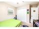 A bright bedroom with a closet, window, and green bedspread at 1048 Sunset Trail, Babson Park, FL 33827