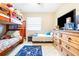 Bright bedroom features a wooden bunk bed, TV, and gaming-themed decor at 1048 Sunset Trail, Babson Park, FL 33827