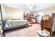 Carpeted bedroom featuring a bed, a fan, a shelving unit and miscellaneous items at 1048 Sunset Trail, Babson Park, FL 33827