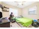 A cozy bedroom with a desk, ceiling fan, and carpeted floor at 1048 Sunset Trail, Babson Park, FL 33827