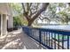 Large wooden deck overlooking the lake with mature trees and a private boat dock at 1048 Sunset Trail, Babson Park, FL 33827