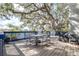 Waterfront deck featuring an outdoor dining set and blue railings, perfect for enjoying the serene view at 1048 Sunset Trail, Babson Park, FL 33827