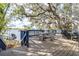 Spacious deck overlooking the lake with mature trees, seating, and access to a private boat dock at 1048 Sunset Trail, Babson Park, FL 33827